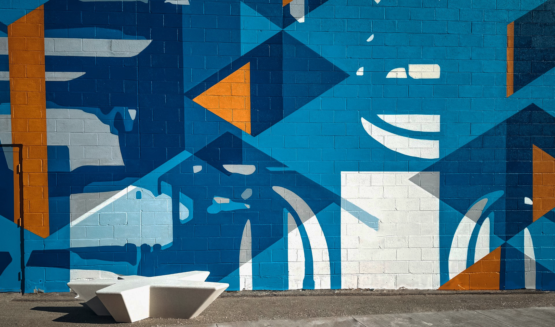 outdoor mural artwork with sculpture concrete bench